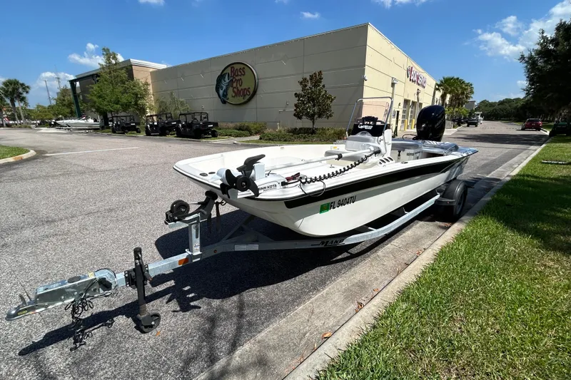 Slide: The Image of 2024 Mako Pro Skiff 17 CC boat on trailer outside Bass Pro Shops. - 2