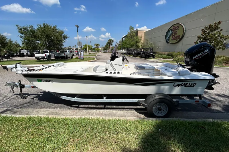 Slide: The Image of 2024 Mako Pro Skiff 17 CC boat on trailer outside Bass Pro Shops. - 3
