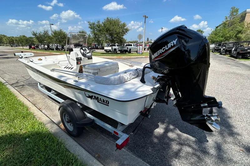 Slide: The Image of 2024 Mako Pro Skiff 17 CC boat with Mercury engine on trailer, parked outdoors. - 4