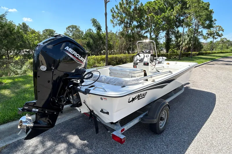 Slide: The Image of 2024 Mako Pro Skiff 17 CC boat on trailer with Mercury outboard motor. - 5