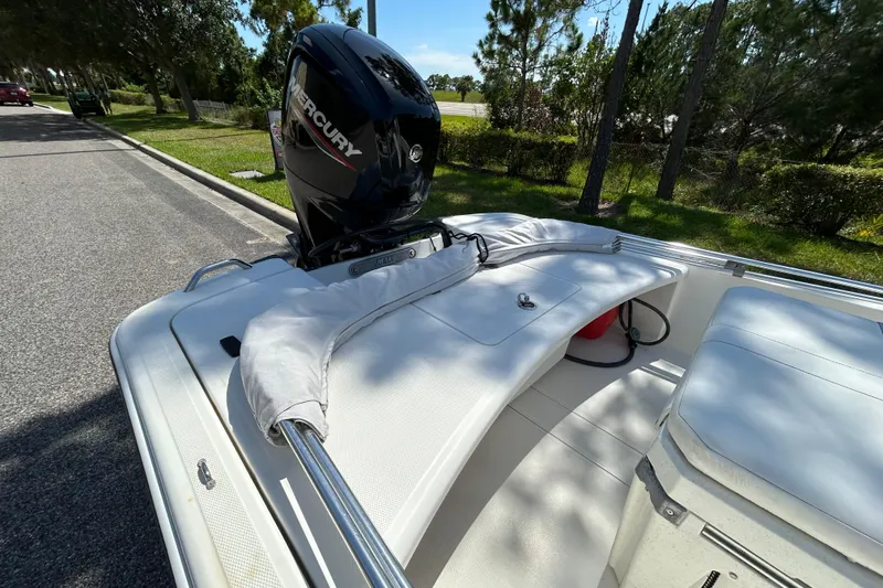 Slide: The Image of 2024 Mako Pro Skiff 17 CC boat with Mercury engine on a sunny day. - 7