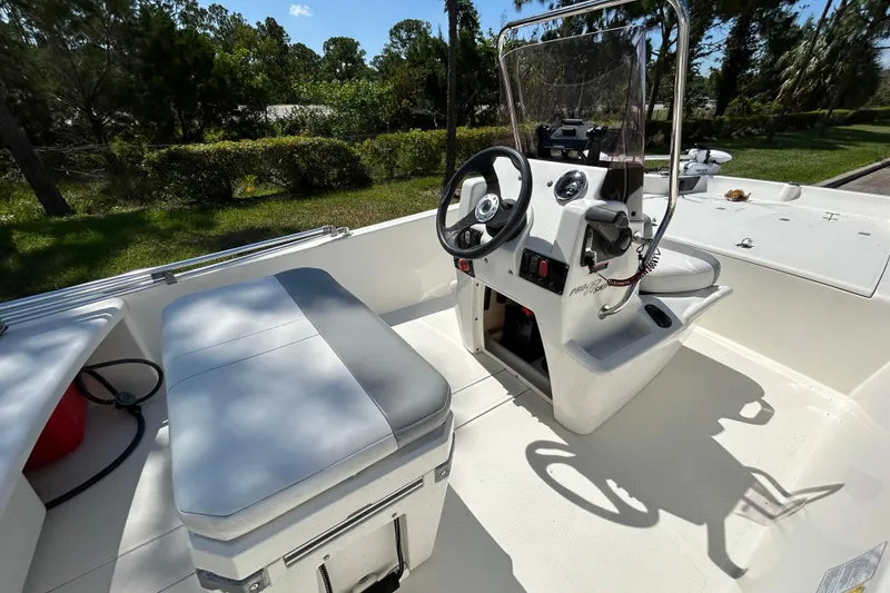 Slide: The Image of 2024 Mako Pro Skiff 17 CC boat interior with steering console and seating. - 8
