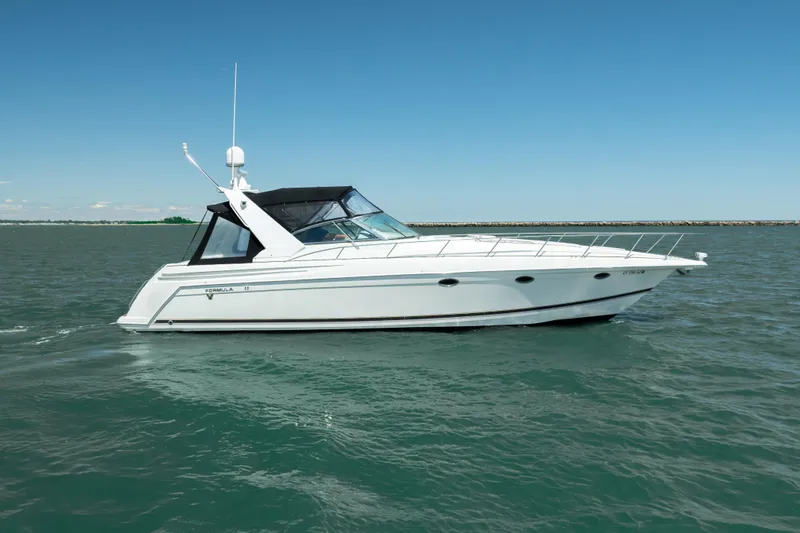 The Image of 2000 Formula 41 Performance Cruiser on open water under clear blue sky. - 1