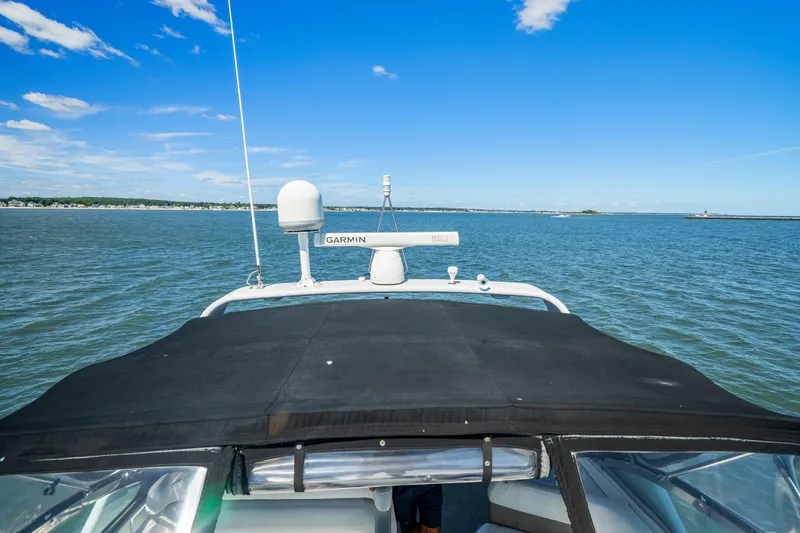 Slide: The Image of 2000 Formula 41 Performance Cruiser on open water under clear blue sky. - 11