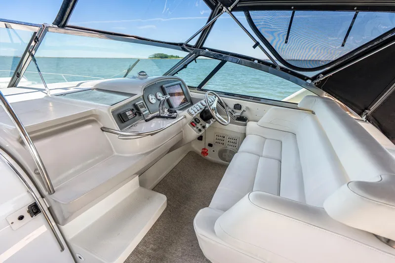 Slide: The Image of Cockpit of 2000 Formula 41 Performance Cruiser with white seating and ocean view. - 15