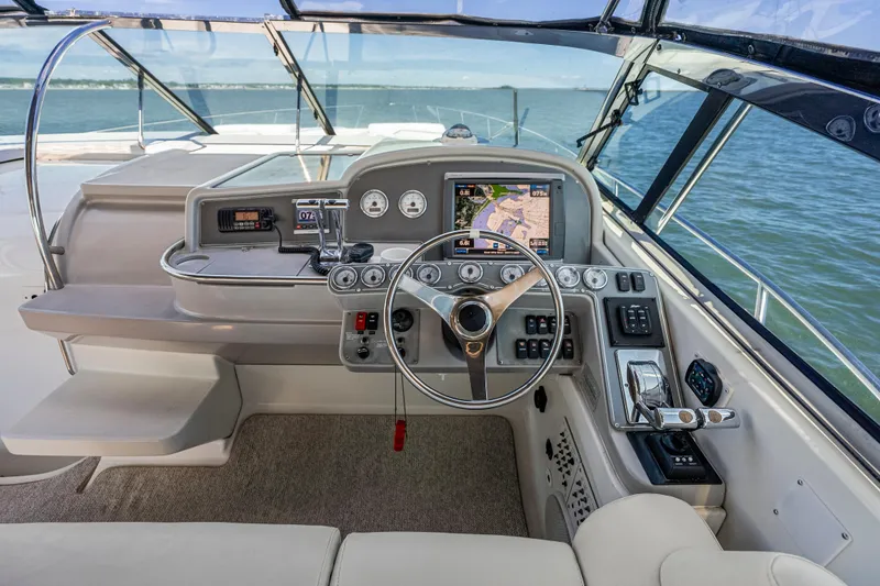 Slide: The Image of Cockpit of 2000 Formula 41 Performance Cruiser with navigation controls and ocean view. - 16