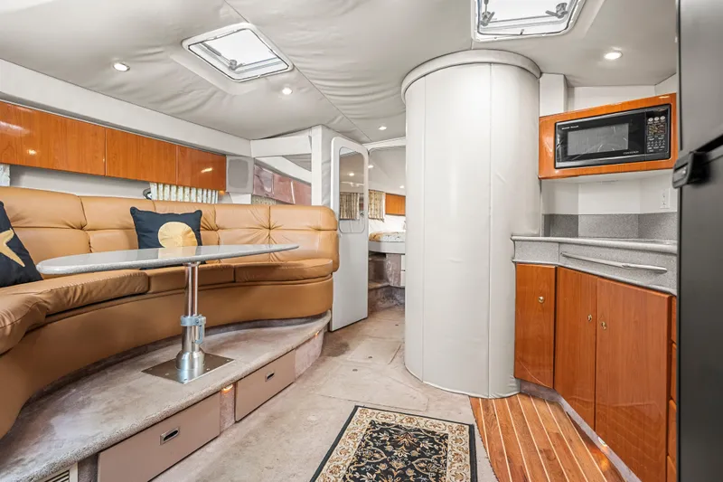 Slide: The Image of Interior of 2000 Formula 41 Performance Cruiser with modern kitchen and cozy seating area. - 18