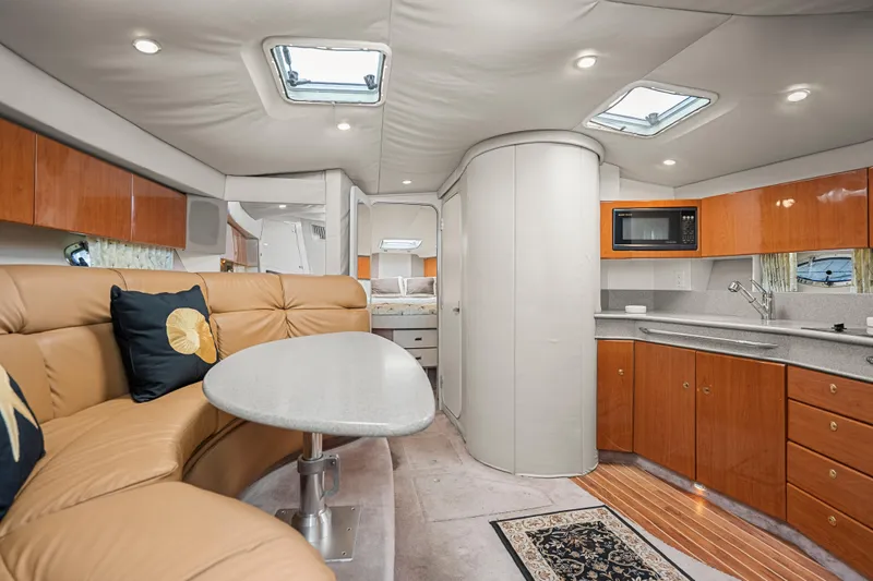 Slide: The Image of Luxurious interior of a 2000 Formula 41 Performance Cruiser with modern kitchen and seating area. - 19