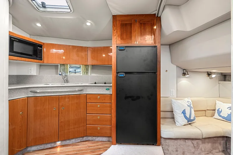 Slide: The Image of Interior of 2000 Formula 41 Performance Cruiser with kitchenette and seating area. - 21