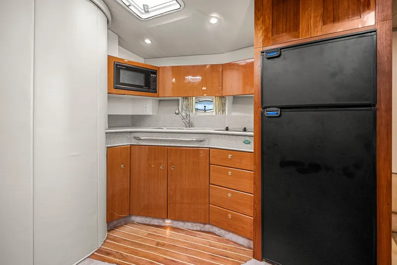 Slide: The Image of Modern kitchen in 2000 Formula 41 Performance Cruiser with wood cabinetry and appliances. - 22