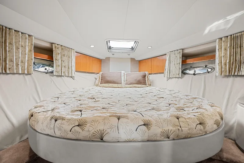 Slide: The Image of Luxurious cabin interior of 2000 Formula 41 Performance Cruiser with elegant bedding and porthole windows. - 25