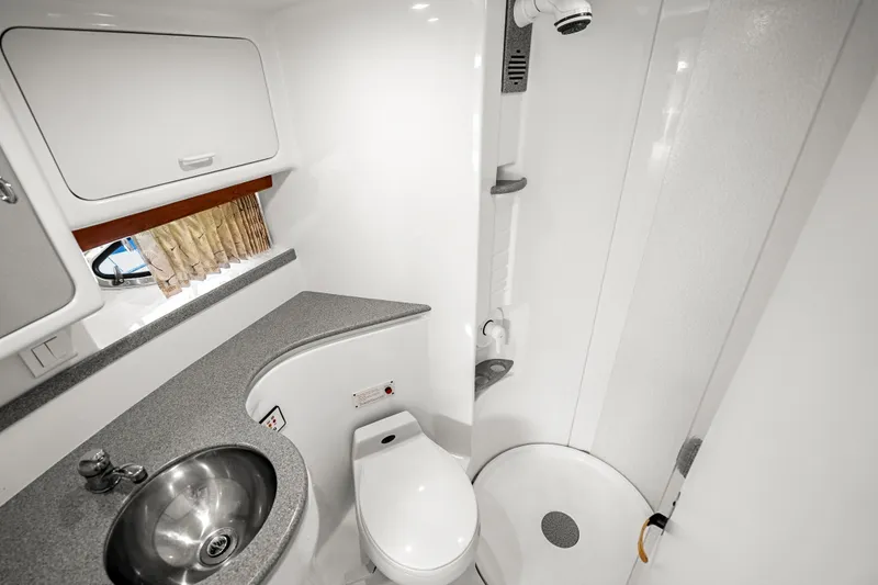 Slide: The Image of Bathroom interior of 2000 Formula 41 Performance Cruiser with sink, toilet, and shower. - 28