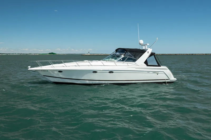 Slide: The Image of 2000 Formula 41 Performance Cruiser on open water under clear blue sky. - 3