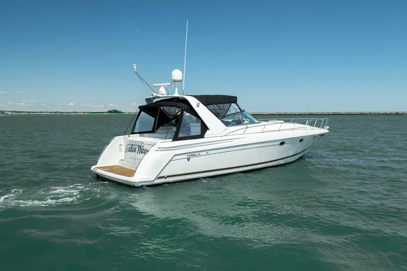 Slide: The Image of 2000 Formula 41 Performance Cruiser on open water, showcasing sleek design and luxury features. - 4