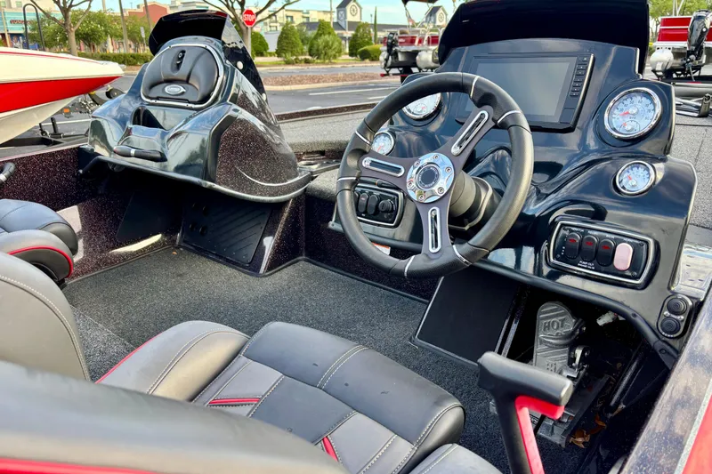 Slide: The Image of Interior of a 2018 Nitro Z18 boat featuring a sleek dashboard and steering wheel. - 3