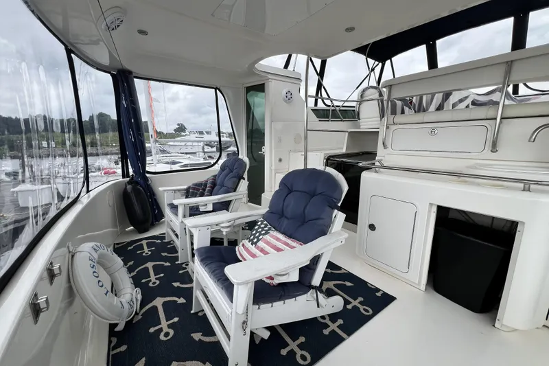 Slide: The Image of 1999 Sea Ray 420 Aft Cabin interior with nautical decor and comfortable seating. - 10