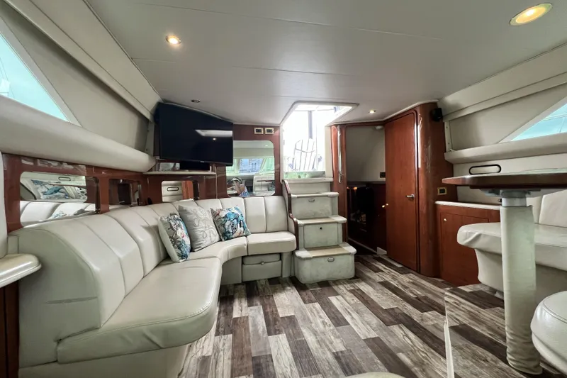 Slide: The Image of Luxurious interior of a 1999 Sea Ray 420 Aft Cabin yacht with plush seating and modern decor. - 11