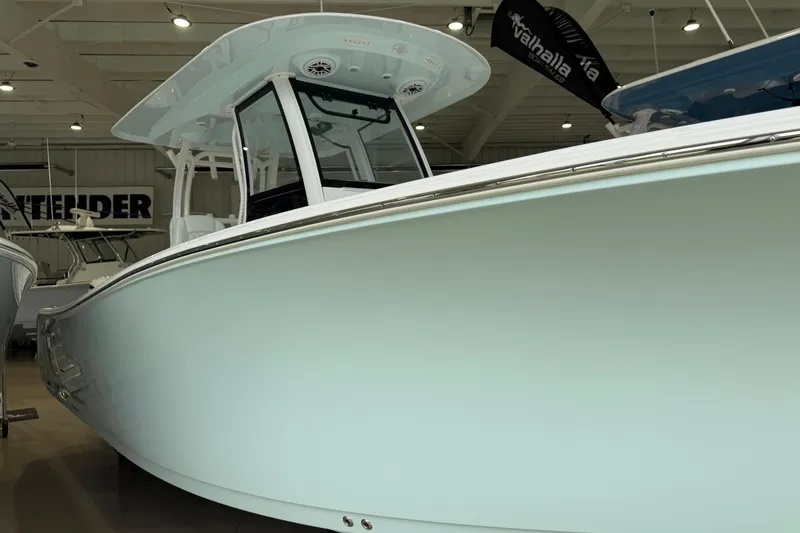 The Image of 2026 Sportsman Open 282 Center Console boat displayed in a showroom. - 0