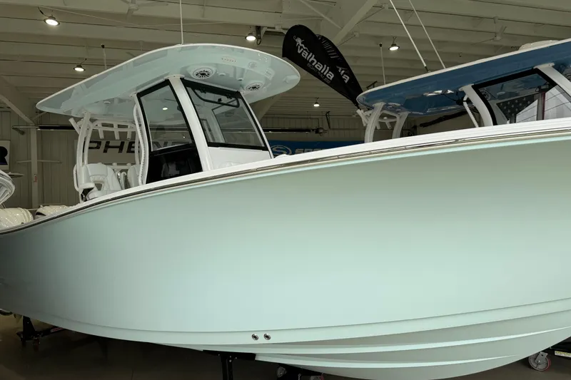Slide: The Image of 2026 Sportsman Open 282 Center Console boat displayed indoors. - 1