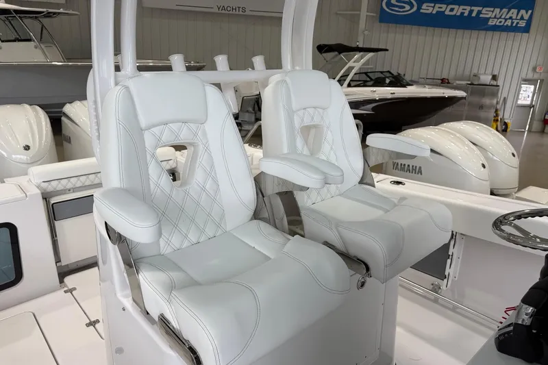 Slide: The Image of 2026 Sportsman Open 282 Center Console with luxurious white seating in a showroom. - 10