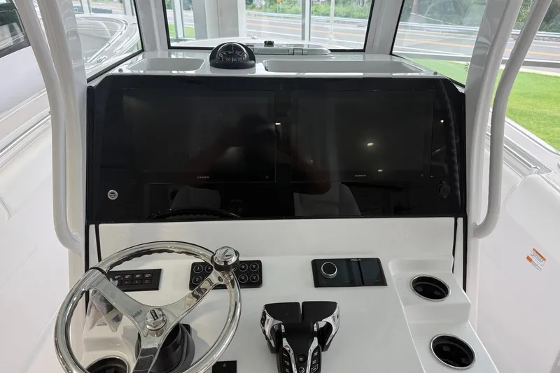 Slide: The Image of 2026 Sportsman Open 282 Center Console helm with dual displays and modern controls. - 11