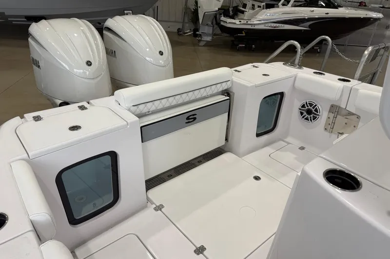 Slide: The Image of 2026 Sportsman Open 282 Center Console boat interior with Yamaha engines, featuring seating and storage. - 14