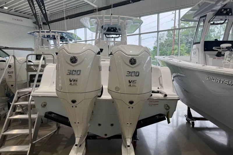 Slide: The Image of 2026 Sportsman Open 282 Center Console with twin Yamaha 300 V6 engines in showroom. - 16