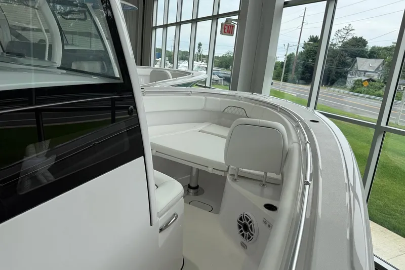 Slide: The Image of 2026 Sportsman Open 282 Center Console boat interior with seating and speaker, displayed indoors. - 3
