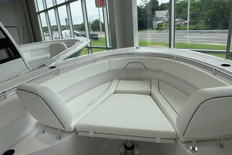 Slide: The Image of 2026 Sportsman Open 282 Center Console boat interior with white cushioned seating. - 5