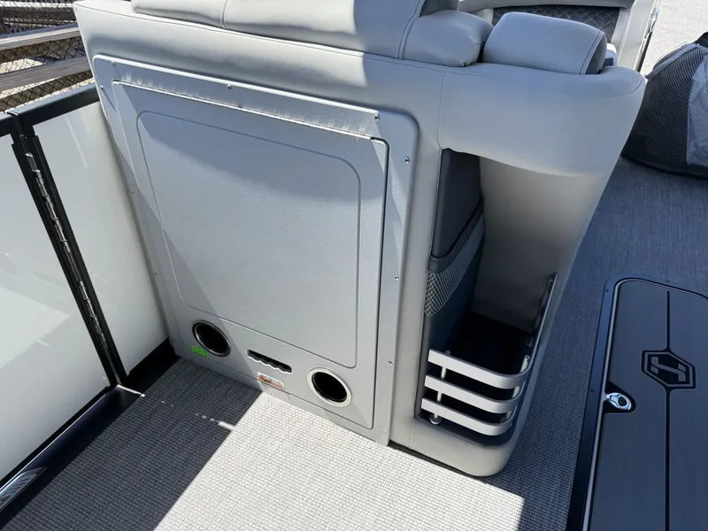 Slide: The Image of The image shows a gray seating area on a boat with storage and cup holders. - 29