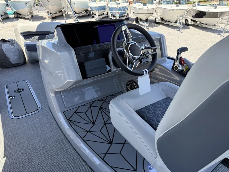 Slide: The Image of The image shows the cockpit of a 2027 Harris Grand Mariner 250 with a modern steering wheel and instruments. - 31