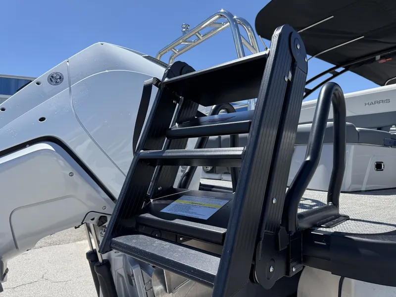 Slide: The Image of A black boat ladder leads into the interior of a modern boat with gray seating. - 9
