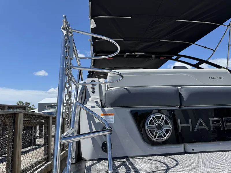 Slide: The Image of The image shows the stern of a Harris Grand Mariner 250 with a black sunshade and speaker. - 13