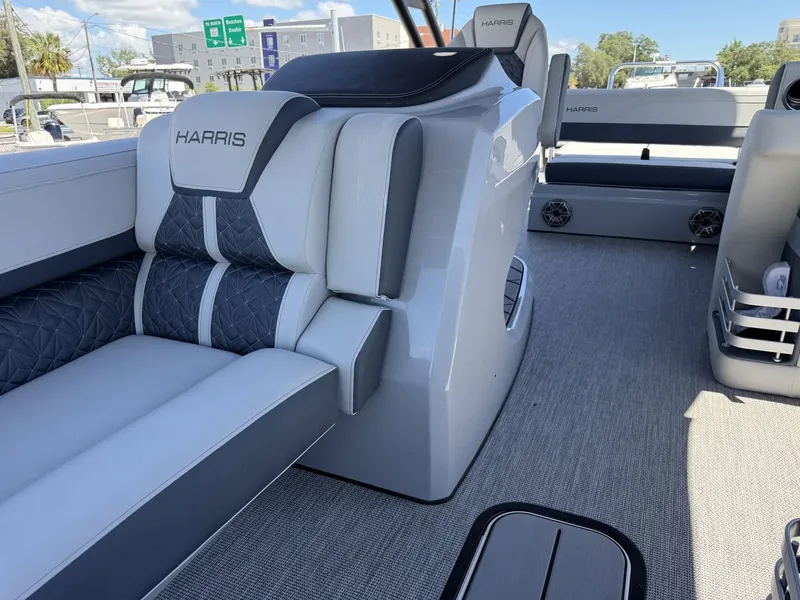 Slide: The Image of Interior of a 2027 Harris Grand Mariner 250 with modern gray and white seating. - 25
