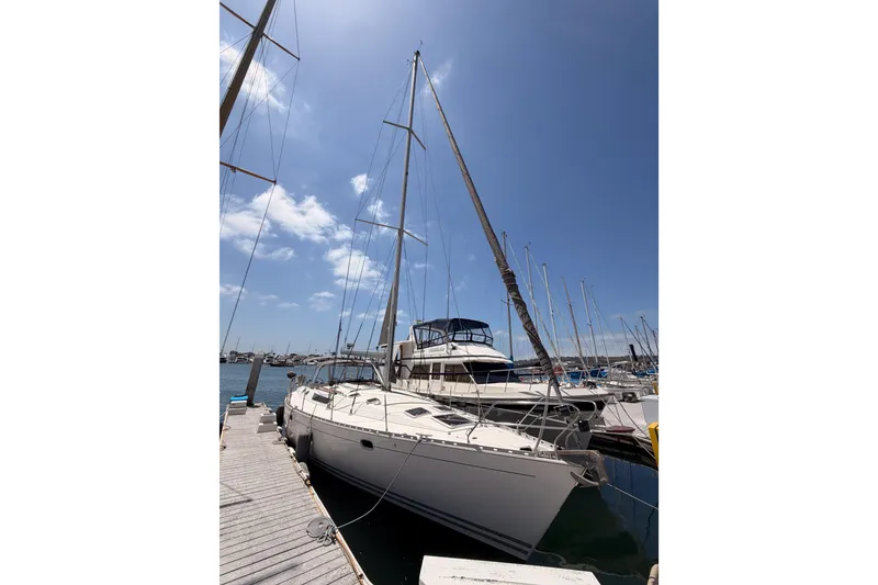Slide: The Image of Sailboat Jeanneau Sun Odyssey 45.2, 1999 model, docked at marina under clear blue sky. - 1