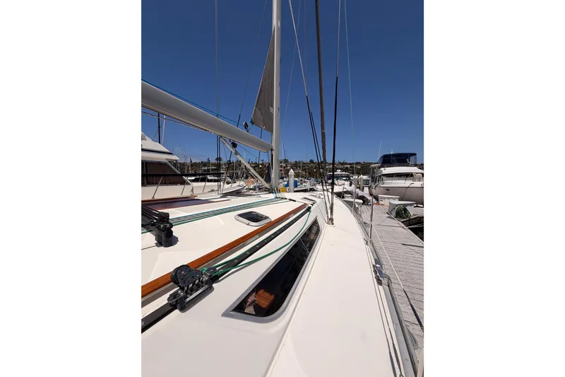 Slide: The Image of Jeanneau Sun Odyssey 45.2 sailboat docked, showcasing deck and rigging, 1999 model. - 12