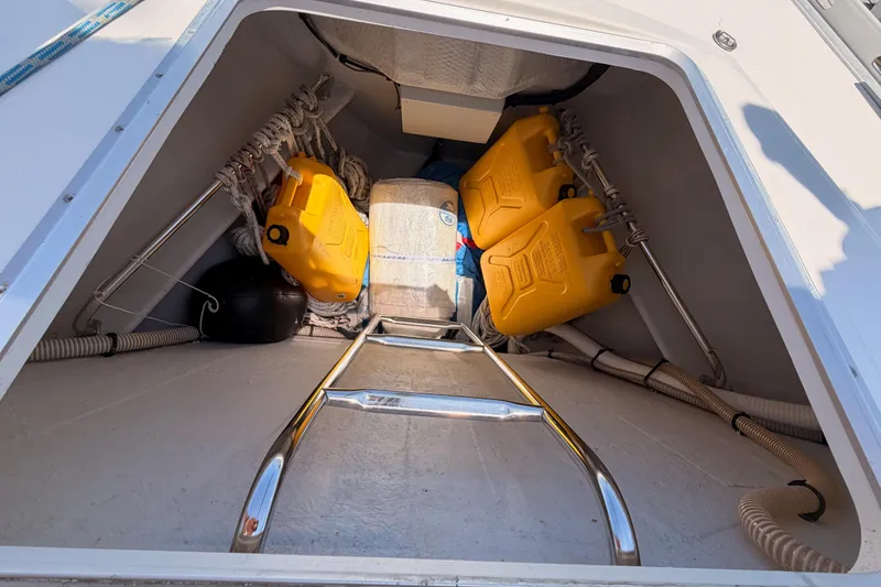 Slide: The Image of Storage compartment of 1999 Jeanneau Sun Odyssey 45.2 with yellow fuel containers and ropes. - 15