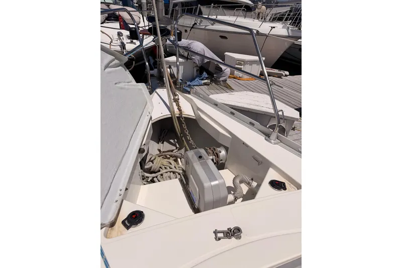 Slide: The Image of Jeanneau Sun Odyssey 45.2 sailboat deck with open storage, docked at marina. - 16