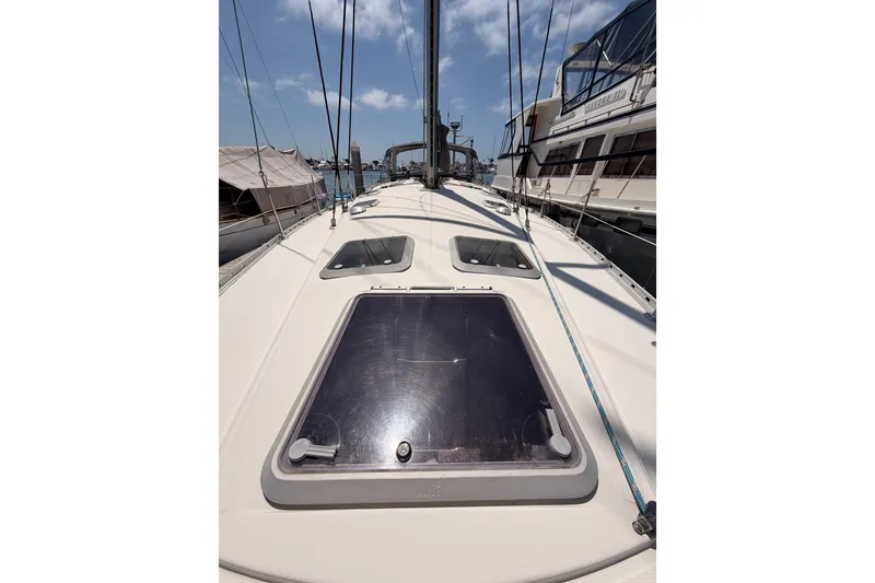 Slide: The Image of 1999 Jeanneau Sun Odyssey 45.2 sailboat deck with hatches, docked in marina. - 18