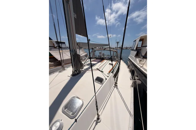 Slide: The Image of Jeanneau Sun Odyssey 45.2 sailboat deck, 1999 model, docked under clear blue sky. - 19