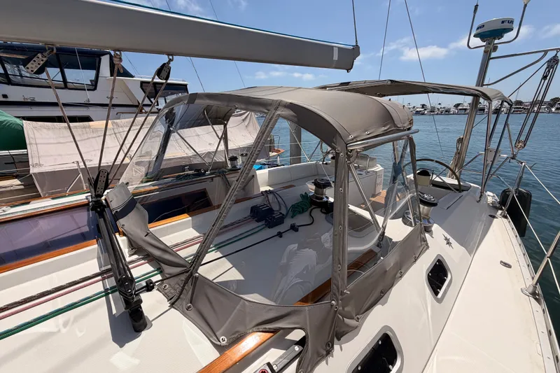 Slide: The Image of 1999 Jeanneau Sun Odyssey 45.2 sailboat with cockpit cover, docked in a marina. - 21