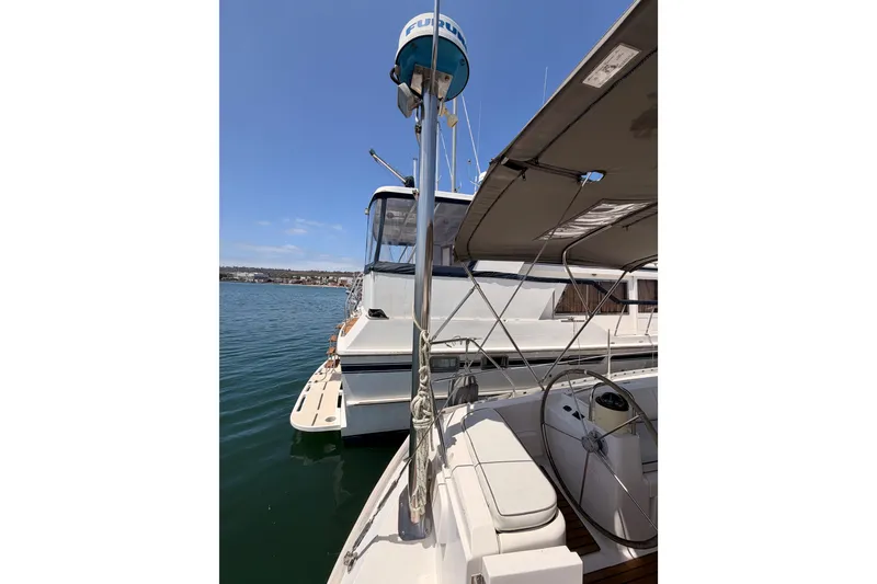 Slide: The Image of Jeanneau Sun Odyssey 45.2 sailboat, 1999 model, docked with clear blue sky background. - 26