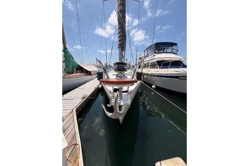 Slide: The Image of 1999 Jeanneau Sun Odyssey 45.2 sailboat docked at marina under blue sky. - 3