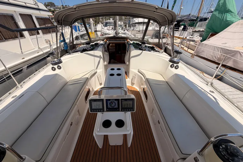 Slide: The Image of Cockpit of 1999 Jeanneau Sun Odyssey 45.2 sailboat, featuring spacious seating and navigation instruments. - 33