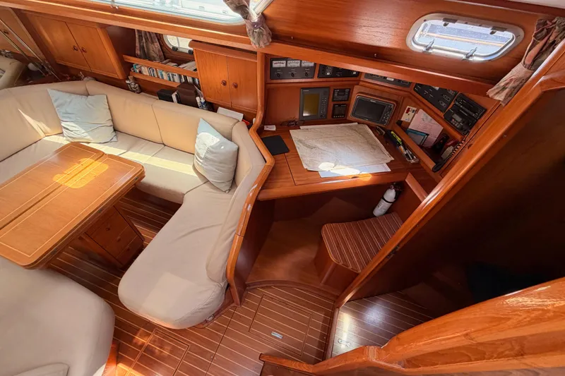 Slide: The Image of Interior of 1999 Jeanneau Sun Odyssey 45.2 yacht with cozy seating and navigation area. - 38