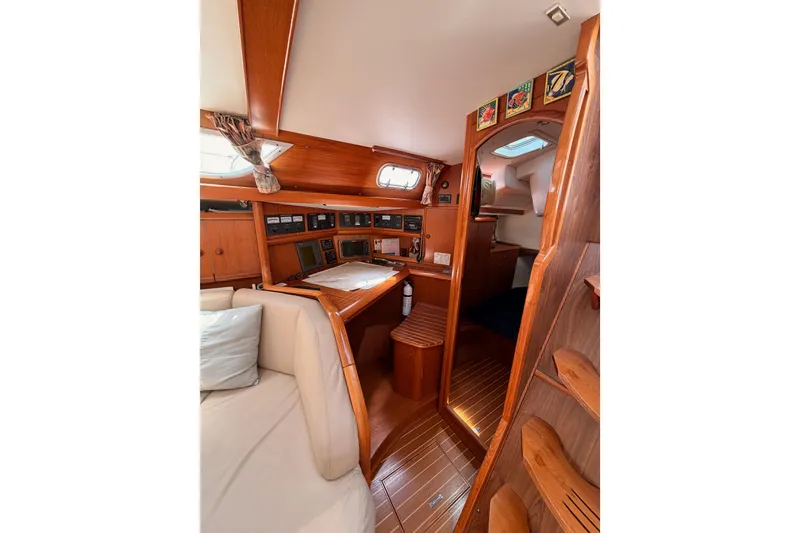 Slide: The Image of Interior of 1999 Jeanneau Sun Odyssey 45.2 sailboat with wooden finish and navigation station. - 39