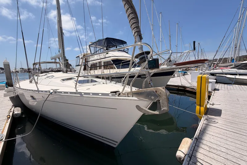 Slide: The Image of 1999 Jeanneau Sun Odyssey 45.2 sailboat docked at marina under clear blue sky. - 4