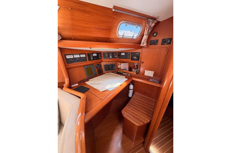 Slide: The Image of Navigation station of 1999 Jeanneau Sun Odyssey 45.2 yacht with wooden interior. - 40