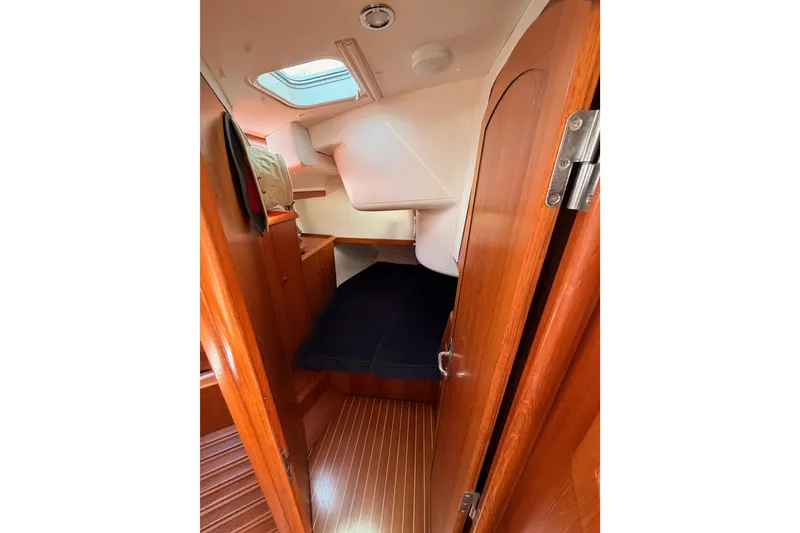 Slide: The Image of Interior cabin of 1999 Jeanneau Sun Odyssey 45.2 sailboat with wooden finish and skylight. - 45