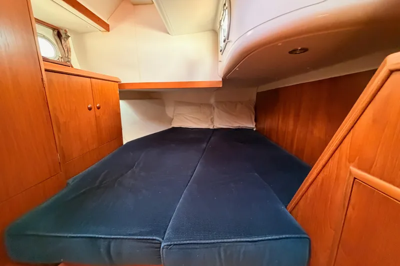 Slide: The Image of Cozy cabin interior of 1999 Jeanneau Sun Odyssey 45.2 sailboat with wooden cabinetry. - 47